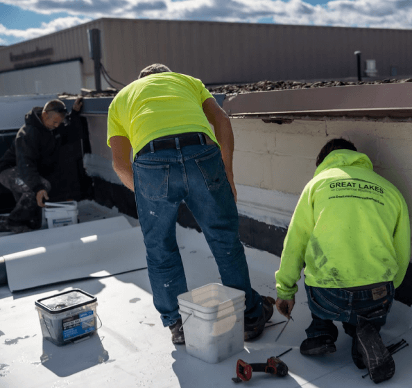 commercial roofing company contractors applying commercial roof coatings and doing commercial roof maintenance